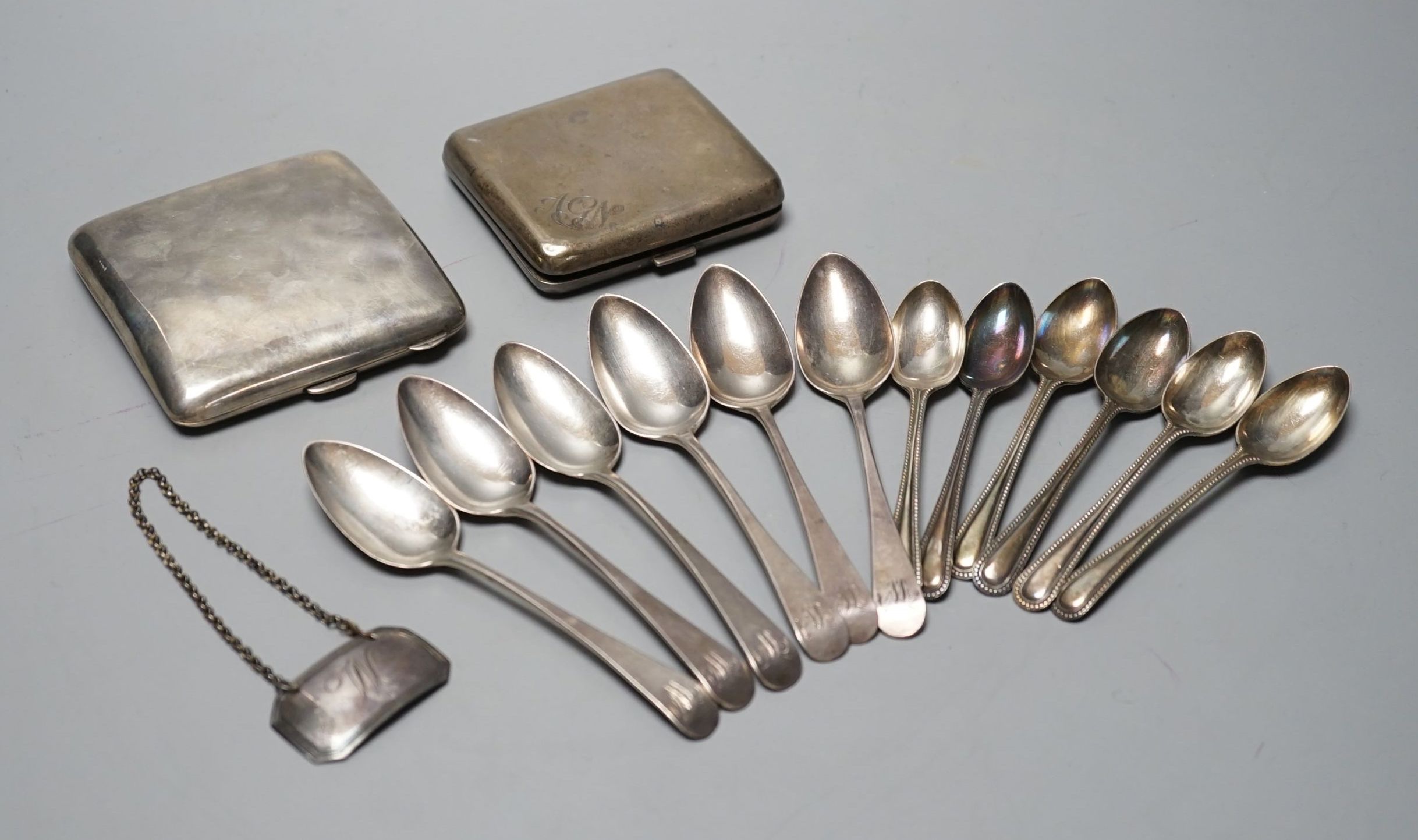 Two silver cigarette cases, a Georgian silver wine label and two sets of six silver teaspoons including London, 1801, 12.5oz.